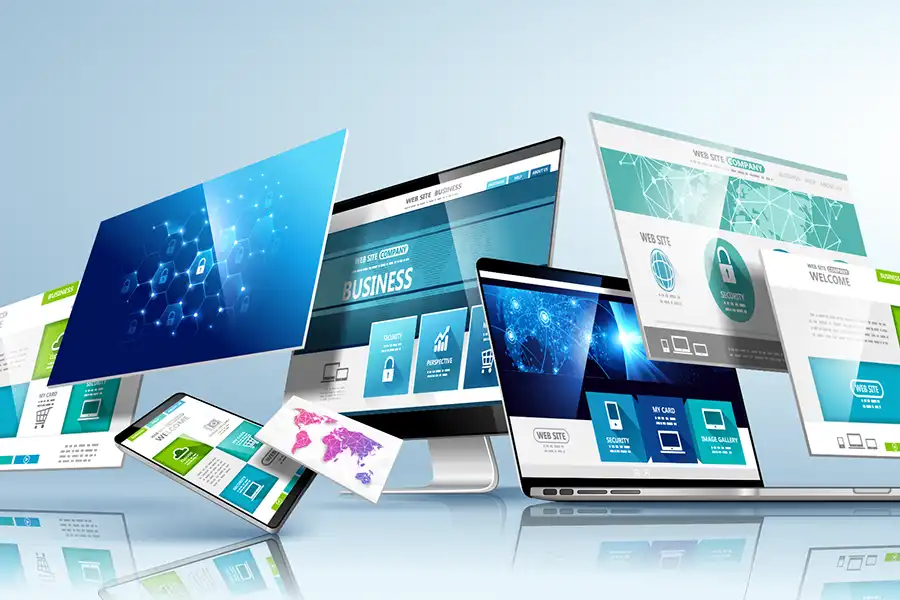 Multiple digital screens, including laptops, tablets, and smartphones, display colorful website designs with graphs, security icons, and business content—showcasing the Top 10 Reasons Manufacturers Need Good Website Design against a light blue gradient background.