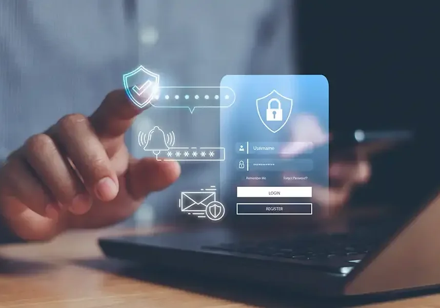 A person uses a laptop, touching virtual security icons, including a shield, lock, and login form—symbolizing cybersecurity and secure online access, such as when learning how to set up Microsoft Authenticator for your work email.