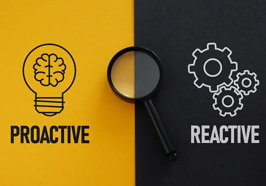 A split image illustrating Being Proactive vs. Reactive with Your Marketing Strategies: the yellow side shows a brain in a lightbulb labeled Proactive, while the black side features gears and a magnifying glass labeled Reactive.